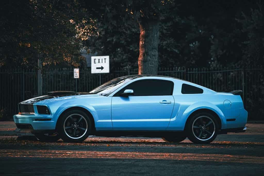 Blue Ford Mustang with dark tinted side and rear windows
