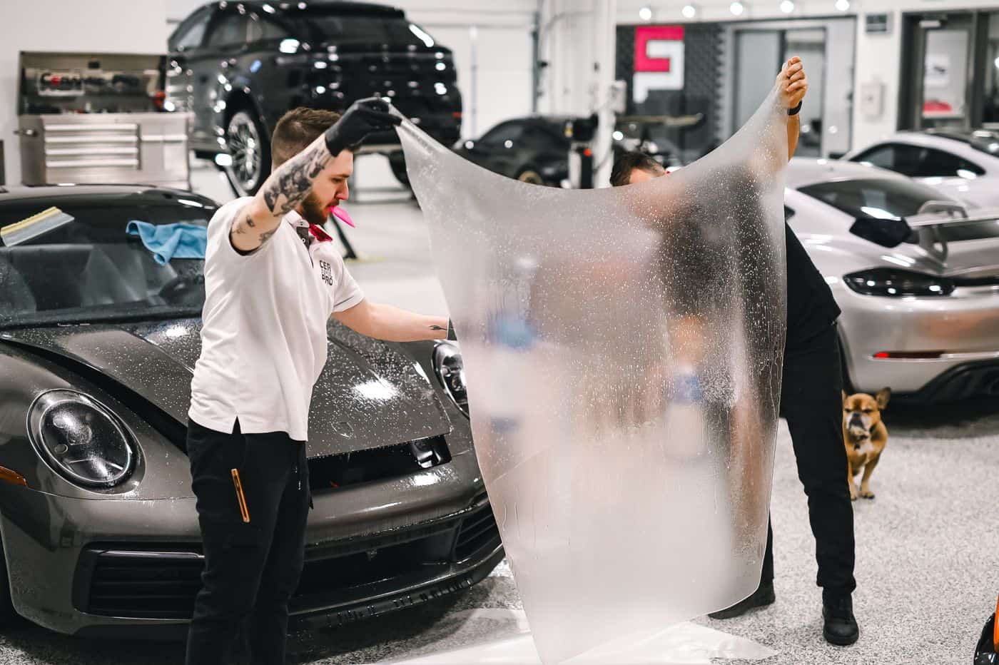 technicians installing 3M Crystalline film on a car