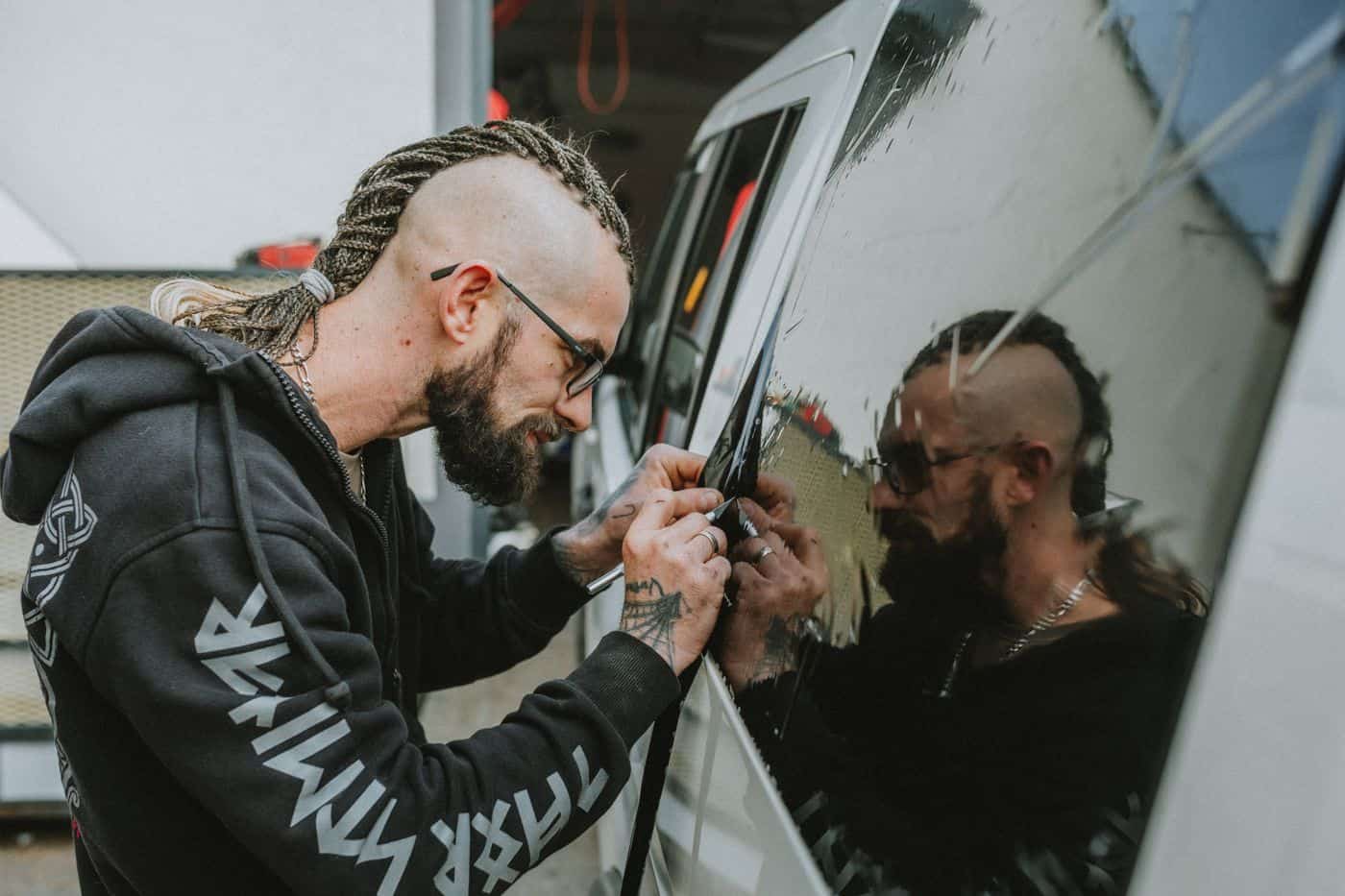 installer applying tint film to a vehicle window